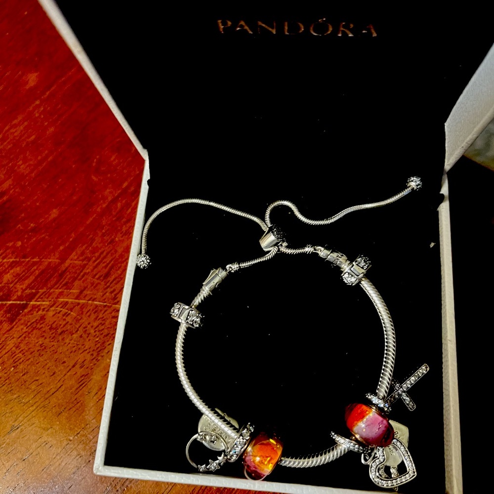 Pandora bracelet with charms. New in box never worn.